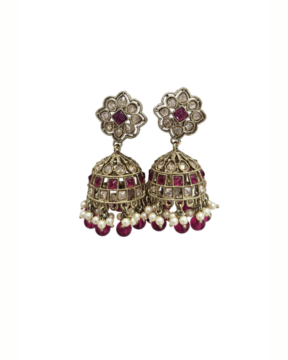 Brass tone jaali jhumka in pink colour