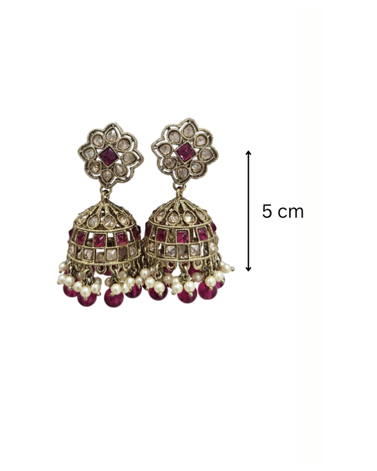 Brass tone jaali jhumka in pink colour